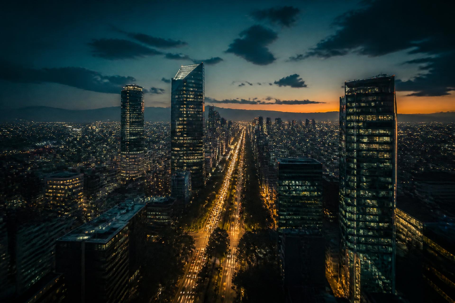 Mexico City skyline along Paseo de la Reforma at dusk